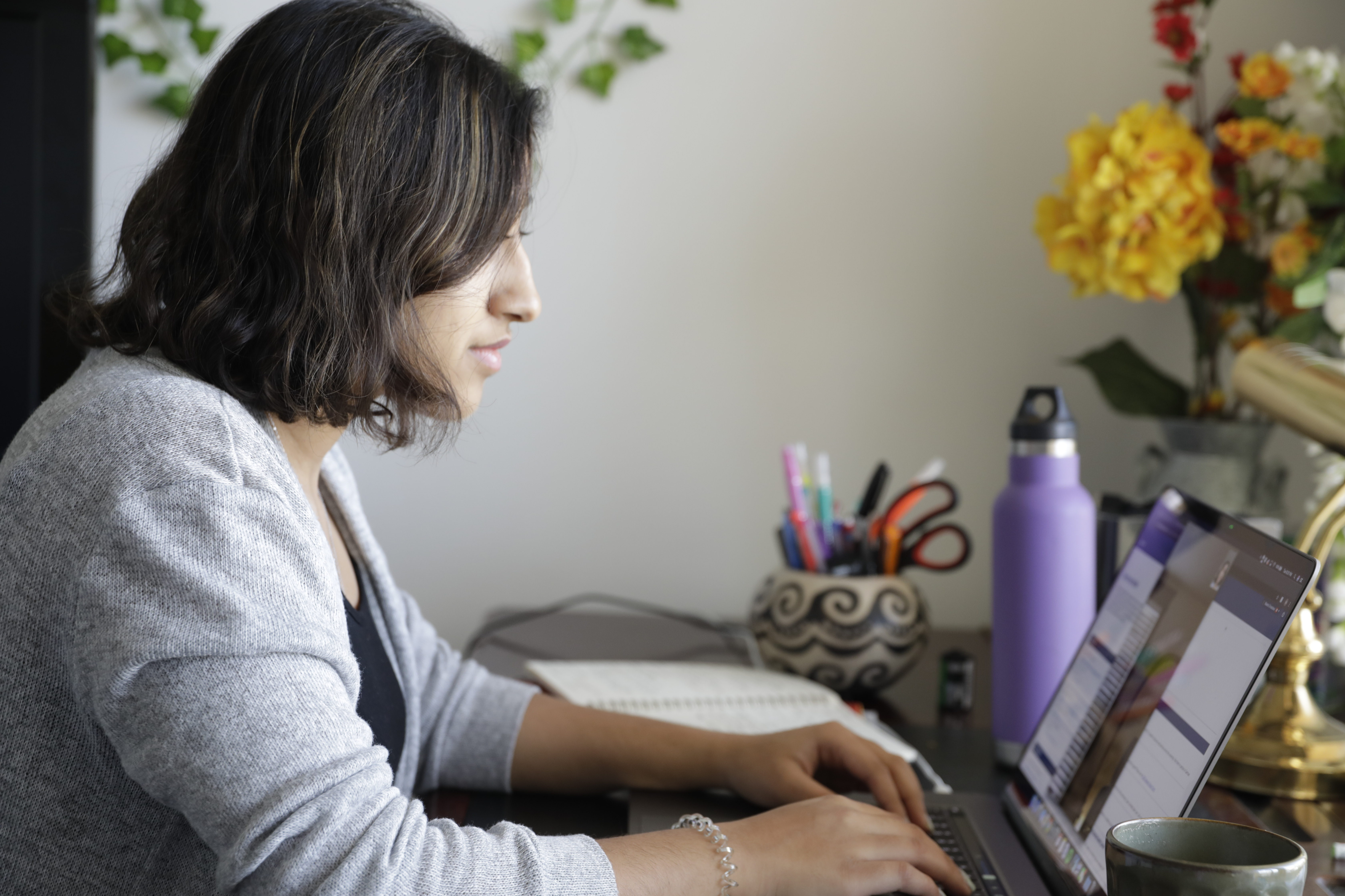 Student writing on a laptop