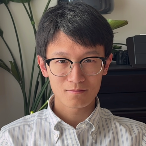 Shi Feng headshot in a white striped button down shirt