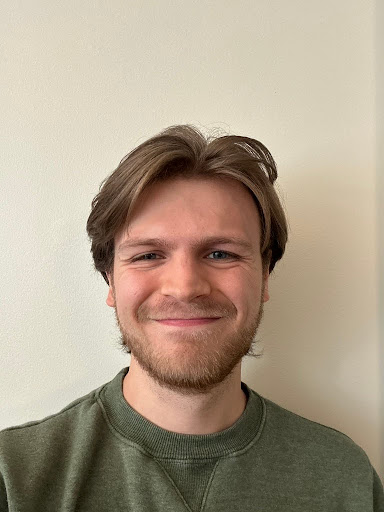 Stephen Hilton headshot in a green sweater 