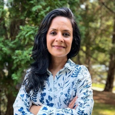 Maliha Aziz headshot with a floral shirt
