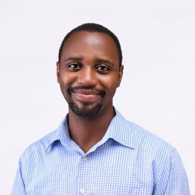 Mobolaji Shobanke headshot in a light blue checkered button up shirt